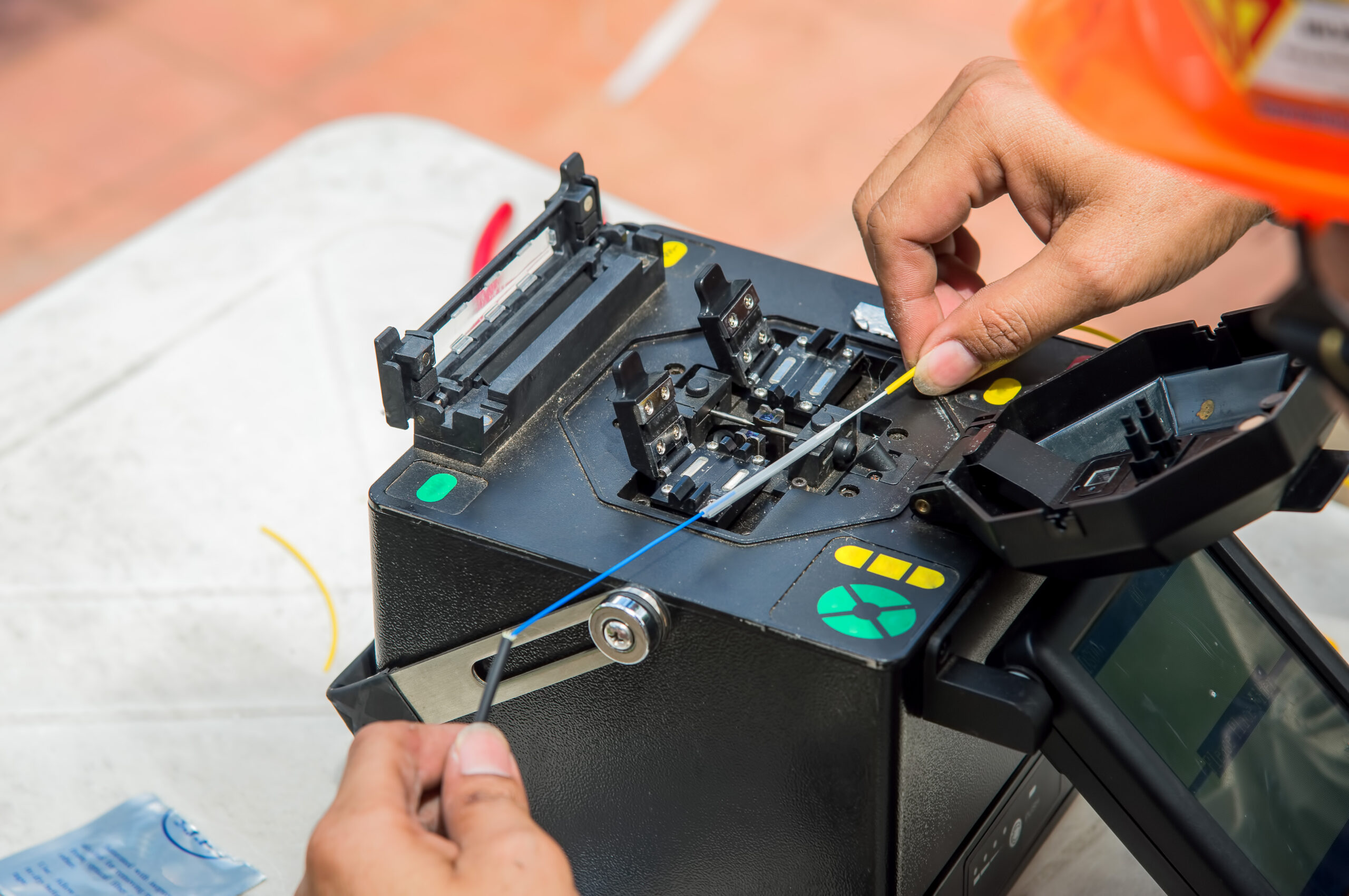 Technicians are cutting and fusion fiber optic cables.